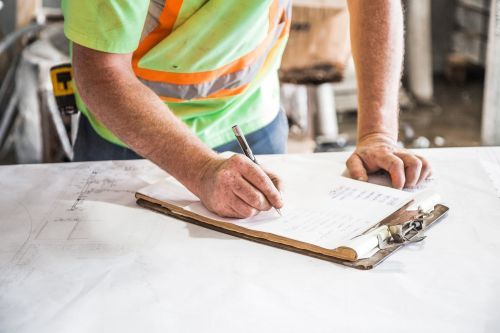 Land surveyor taking notes for the certificate of location