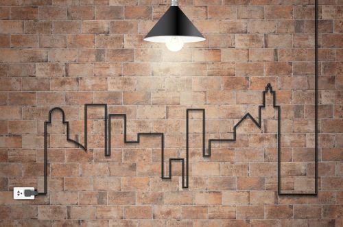 Electrical wire creating a town pattern on a brick wall