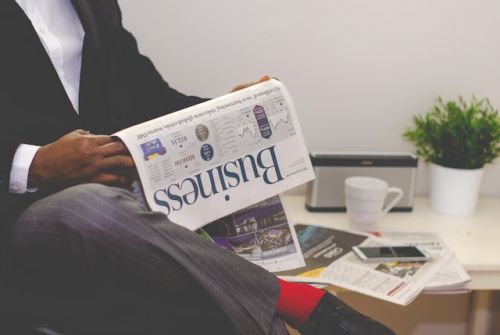 A notary reading a business newspaper