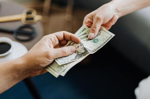 A seller giving money to a real estate broker