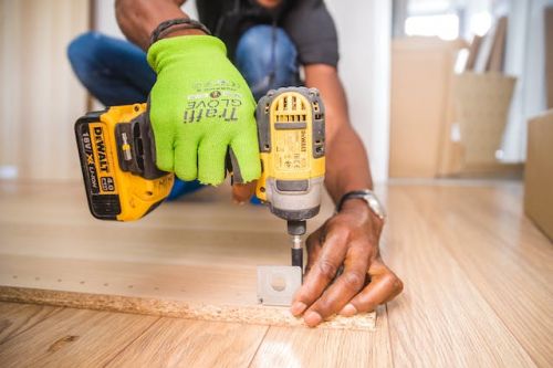 Homme tenant une perceuse pour rénover sa maison